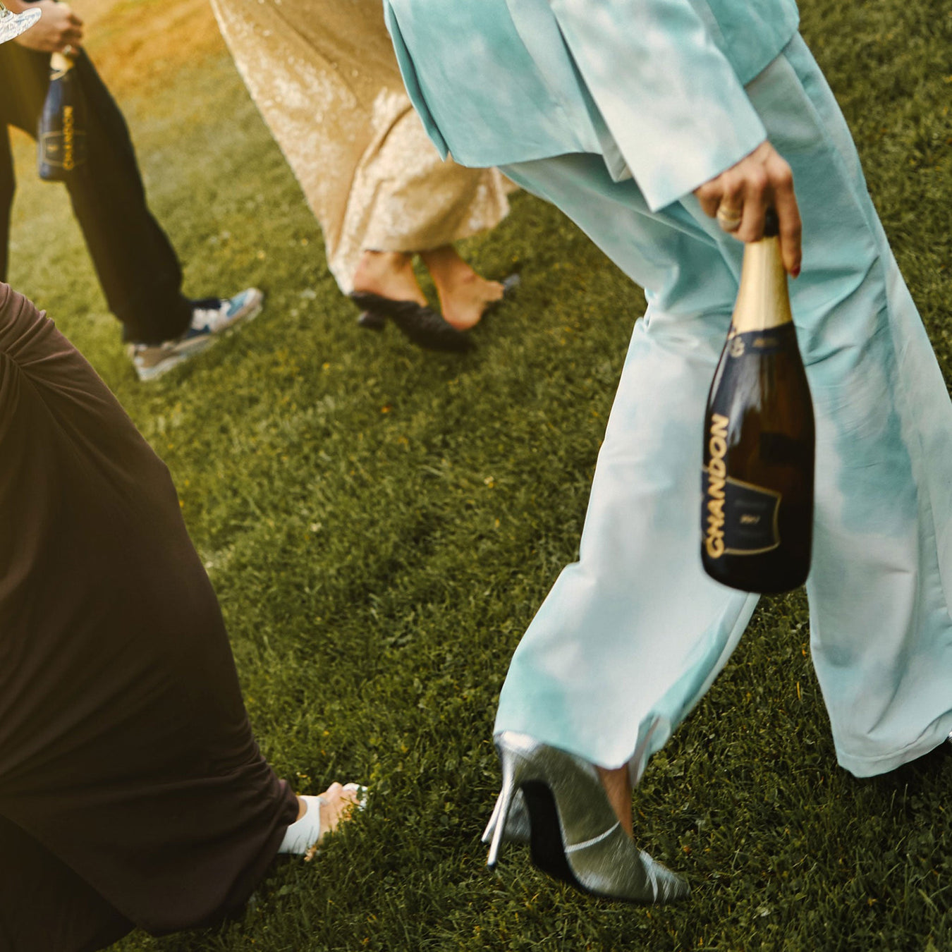 People dressed up holding a bottle of Chandon Vintage Brut - Kent Street Cellars